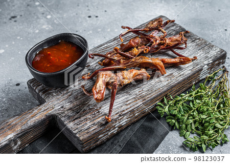 Chinese cuisine Spicy Dip fried duck tongue. Gray background. Top view 98123037