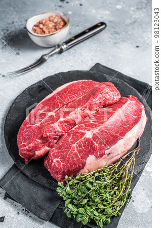Raw top blade flat Iron beef organic meat. Gray background. Top View 98123043