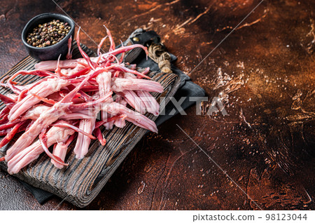 Fresh Raw Duck Tongue, poultry offal. Dark background. Top view. Copy space Fresh Raw Duck Tongue, poultry offal. Dark background. Top view. Copy space 98123044