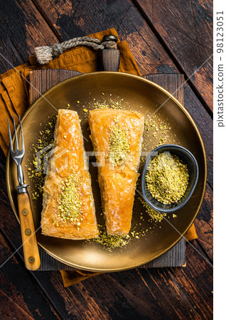 Carrot Slice Baklava, Turkish Havuc Dilim Baklava with pistachio. Wooden background. Top view Carrot Slice Baklava, Turkish Havuc Dilim Baklava with pistachio. Wooden background. Top view 98123051