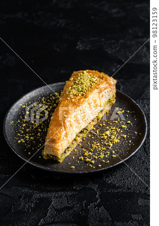 Turkish Havuc Dilim Baklava with pistachio, Carrot Slice Baklava. Black background. Top view 98123159