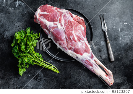 Ready for cooking raw lamb mutton leg with Thigh. Black background. Top view Ready for cooking raw lamb mutton leg with Thigh. Black background. Top view 98123207