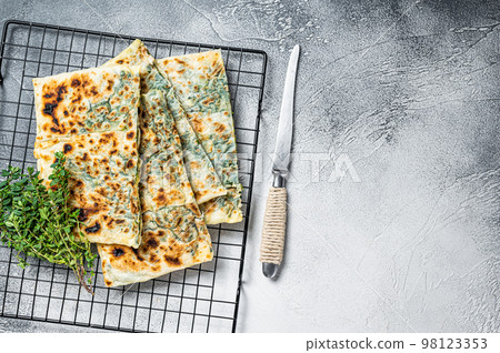 Gozleme Turkish stuffed pastrie, flatbread with greens and cheese. White background. Top view. Copy space 98123353