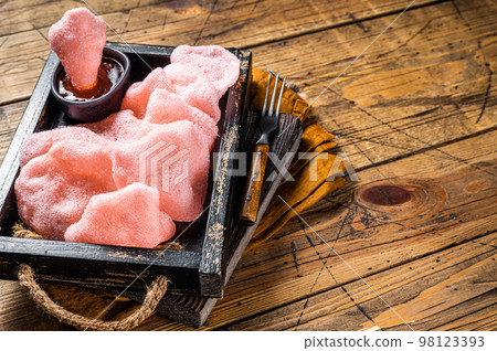 Vietnamese Crunchy kerupuk, prawn shrimp crackers, chips in a box with sauce. Wooden background. Top view. Copy space Vietnamese Crunchy kerupuk, prawn shrimp crackers, chips in a box with sauce. Wooden background. Top view. Copy space 98123393