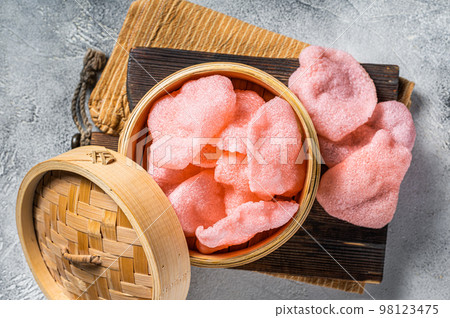 Indonesian prawn shrimp crackers or chips with sauce. White background. Top view Indonesian prawn shrimp crackers or chips with sauce. White background. Top view 98123475
