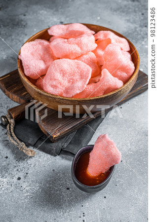 Crunchy kerupuk prawn shrimp crackers, chips. Gray background. Top view 98123486