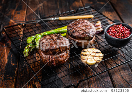 Fillet Mignon grilled Steak with asparagus, beef tenderloin meat. Wooden background. Top view 98123506