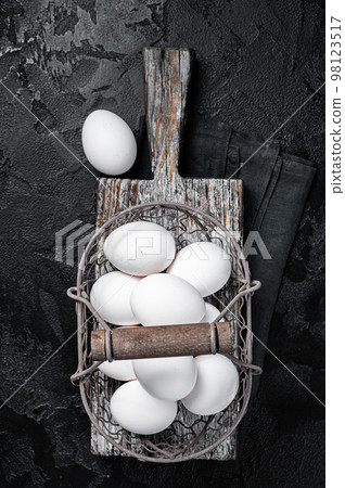 Basket with white chicken eggs. Black background. Top view 98123517