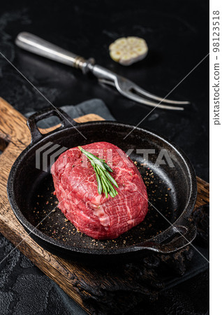 Prime Fillet Mignon Beef steak ready for cooking, Dry aged raw tenderloin meat. Black background. Top view 98123518