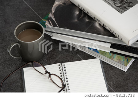 Art book, notebook, glasses and drink 98123738