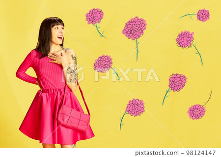 Creative colorful design. Modern art collage. Emotive, beautiful young girl in pink clothes posing over bright yellow background with flowers 98124147