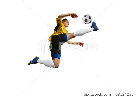 Kicking ball in a jump. Young professional female football, soccer player in motion, training, playing isolated over white background Kicking ball in a jump. Young professional female football, soccer player in motion, training, playing isolated over white background 98124253