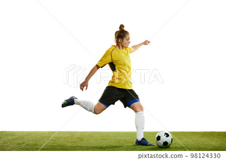 Young woman, professional female football player in motion, training, playing football, soccer isolated over white background 98124330