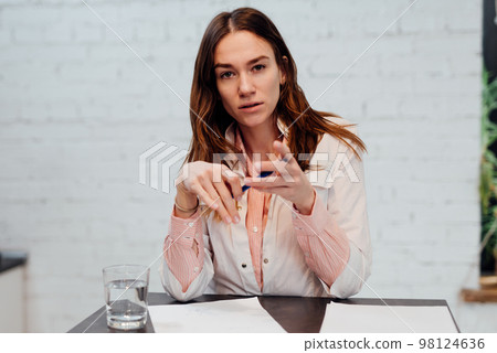 Portrait of a young doctor listening attentively and looking at the camera Portrait of a young doctor listening attentively and looking at the camera 98124636