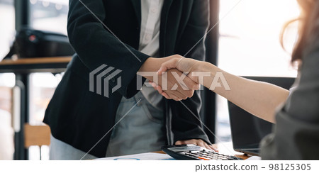 Business people shaking hands, finishing up meeting 98125305