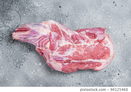 Raw lamb shoulder meat on butcher table. Gray background. Top view 98125468