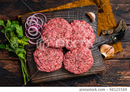 Fresh Raw burger patty, mince beef Meat, uncooked meat cutlets. Wooden background. Top view 98125589