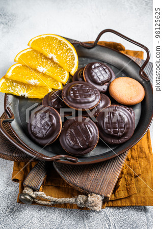 Orange Flavored Round Jaffa Cakes with Chocolate. White background. Top view 98125625