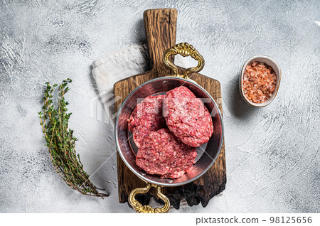 Raw Hamburger patty, groud beef Meat, uncooked meat cutlets. White background. Top view 98125656