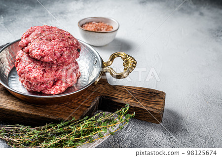 Raw Hamburger patty, groud beef Meat, uncooked meat cutlets. White background. Top view. Space for text 98125674