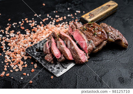 Sliced grilled Lamb fillet steak, mutton meat from leg. Black background. Top view 98125710