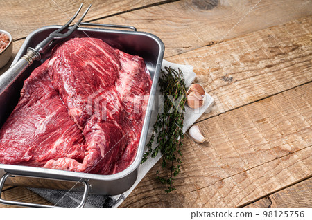 Tri Tip beef steak in steel tray, raw prime meat. Wooden background. Top view. Copy space Tri Tip beef steak in steel tray, raw prime meat. Wooden background. Top view. Copy space 98125756