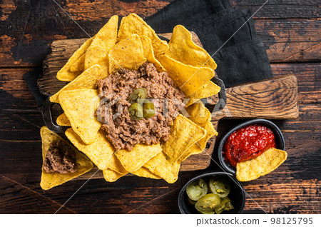 Mexican Baked nachos with chili con carne in a skillet. Wooden background. Top view 98125795
