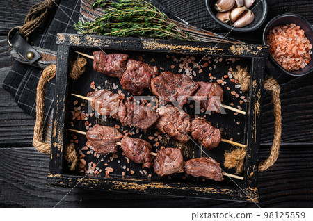 BBQ Beef veal shish kebab Skewers. Black background. Top view 98125859