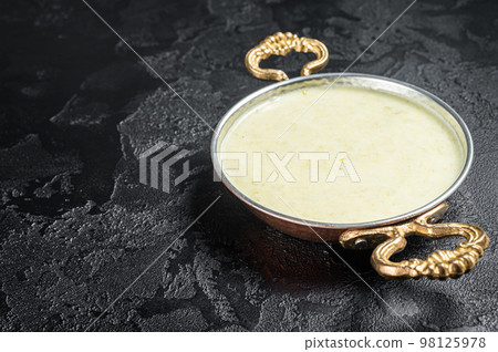 Vichyssoise French cream soup with leek, potato and onion. Black background. Top view. Copy space Vichyssoise French cream soup with leek, potato and onion. Black background. Top view. Copy space 98125978