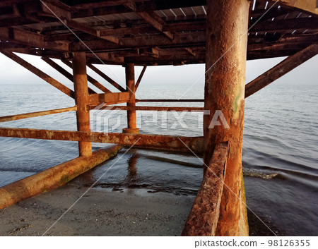 Rusty pillars of the old pier. Rusty pillars of the old pier. 98126355