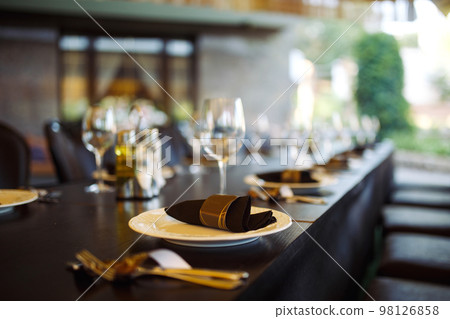 Sparkling glassware stands on long table prepared for wedding dinner. 98126858