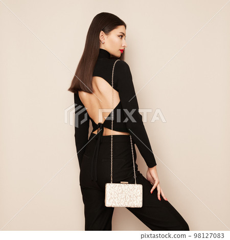 Young woman posing in a black tight suit Young woman posing in a black tight suit 98127083