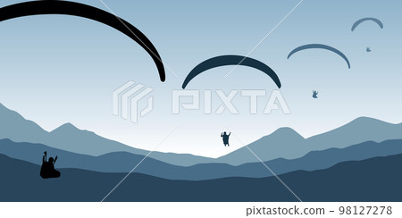 paragliding adventure flying with friends on blue mountain background at sunset 98127278