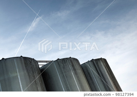 Three used metal cisterns outdoors 98127394