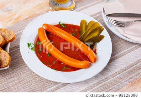 Two Viennese sausages with saftgoulash served on plate Two Viennese sausages with saftgoulash served on plate 98128090