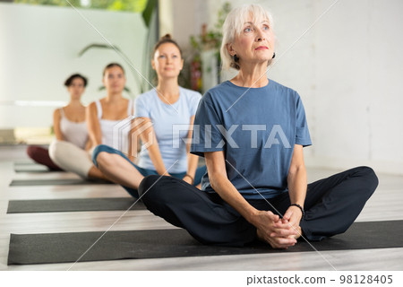Woman making yoga meditation in lotus pose Woman making yoga meditation in lotus pose 98128405