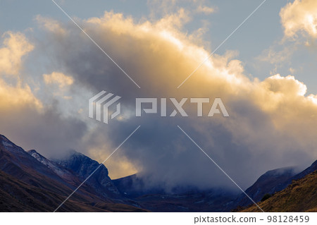 Highlands of North Ossetia. Mountains of the Caucasus. High mountains in the rays of the setting sun. Highlands of North Ossetia. Mountains of the Caucasus. High mountains in the rays of the setting sun. 98128459