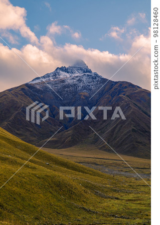 Highlands of North Ossetia. Mountains of the Caucasus. High mountains in the rays of the setting sun. Highlands of North Ossetia. Mountains of the Caucasus. High mountains in the rays of the setting sun. 98128460