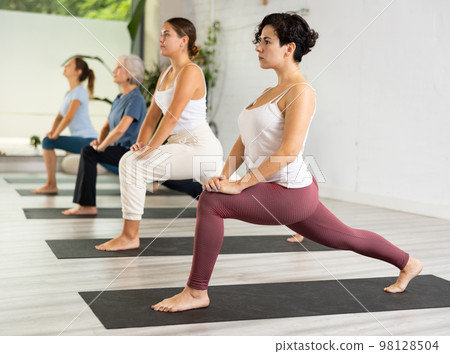 Portrait of young sporty girl having yoga class with group at sports club Portrait of young sporty girl having yoga class with group at sports club 98128504