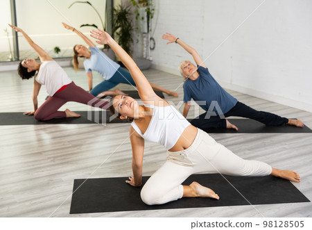 Group of women practicing yoga training - pose bhujangasana Group of women practicing yoga training - pose bhujangasana 98128505