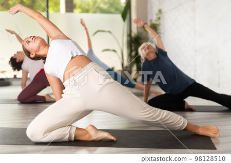 People relaxing and enjoying yoga elements People relaxing and enjoying yoga elements 98128510
