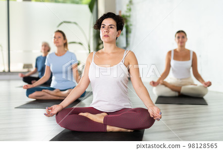 Woman making yoga meditation in lotus pose Woman making yoga meditation in lotus pose 98128565