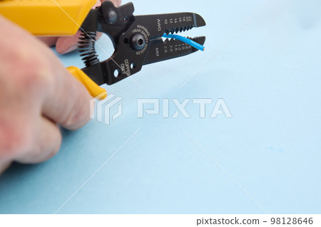 Wire stripping tool look like pliers with number of notches set in jaws. 98128646