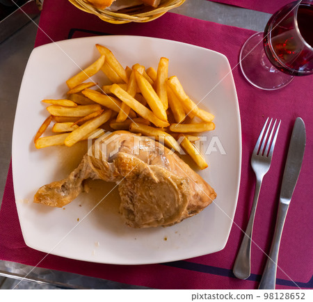 Tasty homemade chicken legs with fried potato Tasty homemade chicken legs with fried potato 98128652