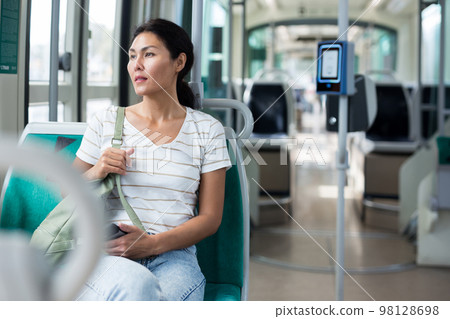 Woman sitting in tram 98128698