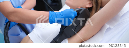 Young woman undergoes laser hair removal procedure in beauty salon Young woman undergoes laser hair removal procedure in beauty salon 98128843