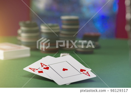 Two aces and stack of Casino Chips in background 98129317