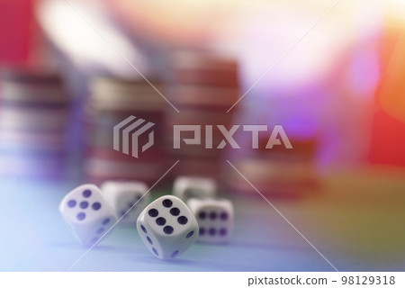 White dice on a green felt table with bokeh background White dice on a green felt table with bokeh background 98129318