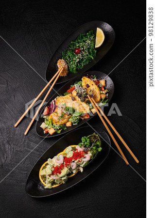 Three different kind of salad salad on a black concrete background Three different kind of salad salad on a black concrete background 98129838