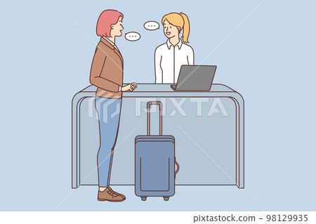 Woman with suitcase talk with administrator on reception  98129935